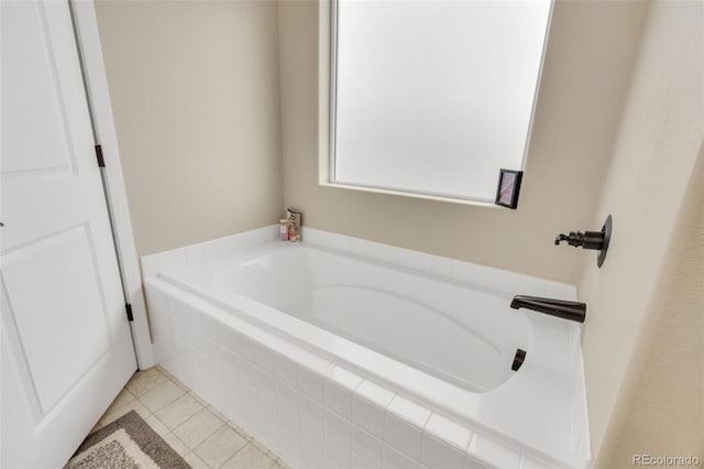 bathroom with tile patterned floors and a garden tub