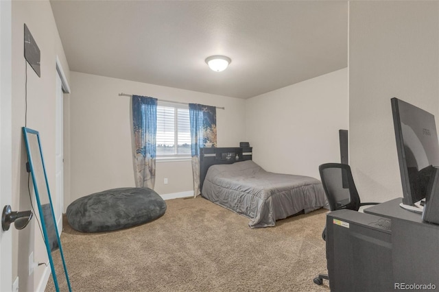 bedroom featuring carpet floors and baseboards