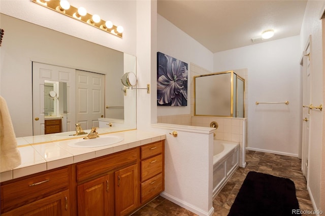 bathroom featuring shower with separate bathtub and vanity