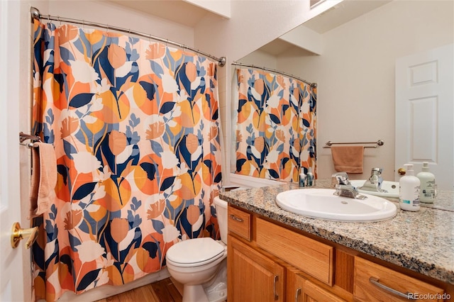 bathroom with hardwood / wood-style flooring, a shower with curtain, vanity, and toilet