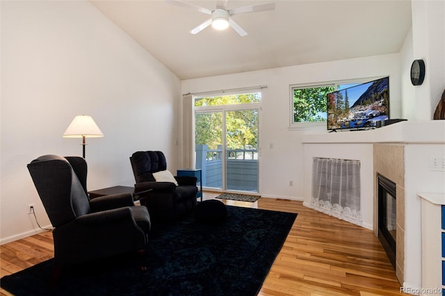 living room featuring ceiling fan, vaulted ceiling, and hardwood / wood-style floors