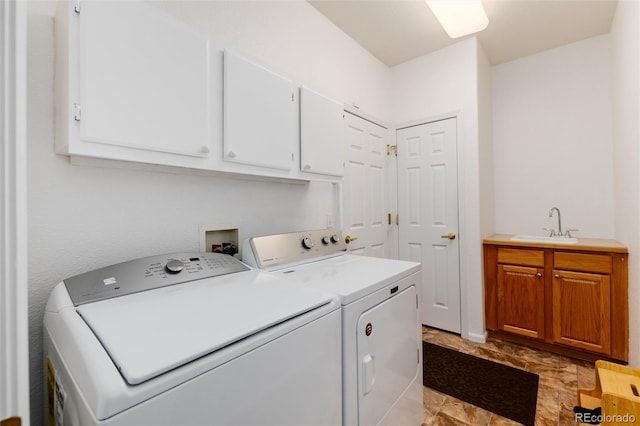 washroom featuring separate washer and dryer, cabinets, and sink