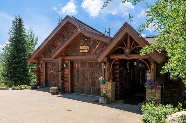 log cabin featuring a garage