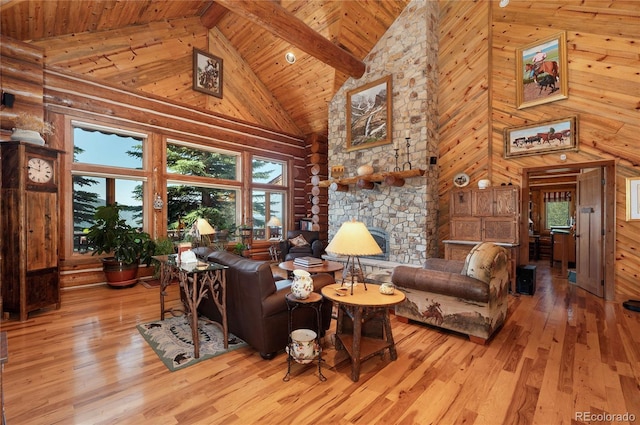 living room with wood-type flooring, wooden ceiling, high vaulted ceiling, wood walls, and a stone fireplace