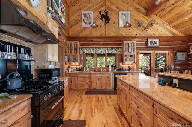 kitchen featuring light hardwood / wood-style floors, pendant lighting, a healthy amount of sunlight, and custom exhaust hood