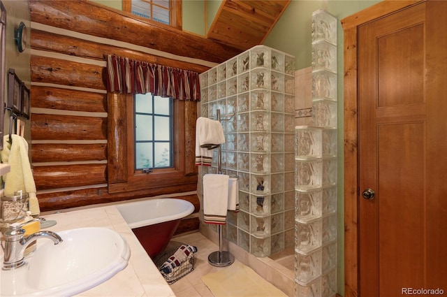 bathroom featuring tile patterned floors, plus walk in shower, and sink