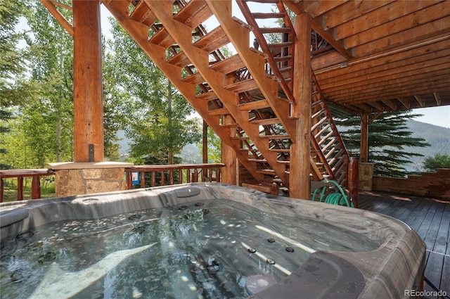 wooden terrace featuring a hot tub