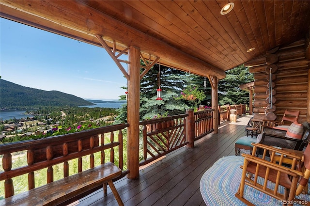 deck with a water and mountain view