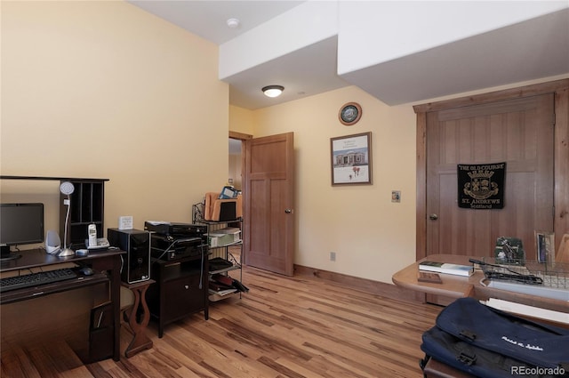 office with light wood-type flooring