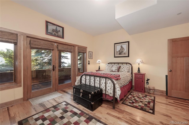 bedroom with light hardwood / wood-style floors and access to exterior