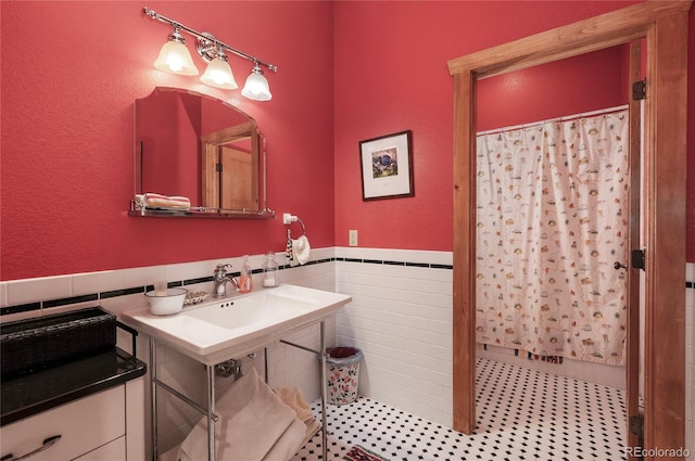 bathroom with sink, tile patterned floors, tasteful backsplash, and tile walls