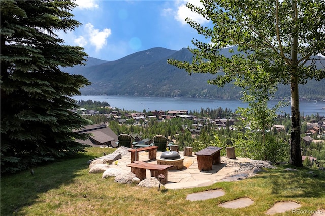 view of yard with a water and mountain view and a patio area