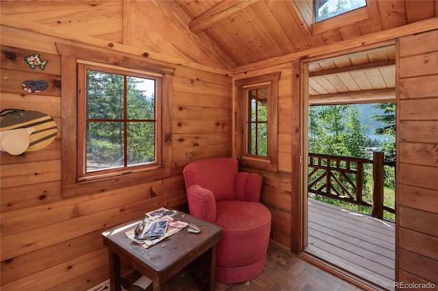 living area with lofted ceiling with skylight and wood ceiling