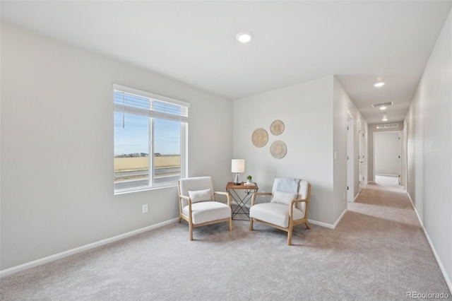 living area featuring visible vents, baseboards, recessed lighting, and carpet flooring