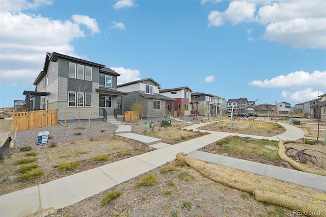 view of front of property featuring fence and a residential view