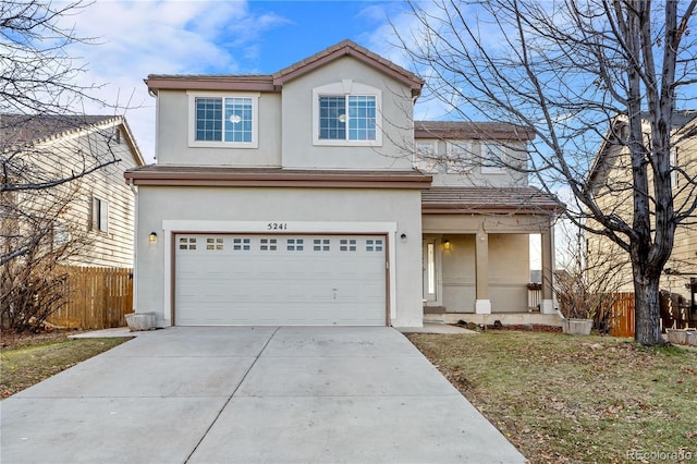 5241 S Shawnee St, Aurora, CO 80015 - traditional-style house featuring stucco siding, a garage, concrete driveway, and a tiled roof