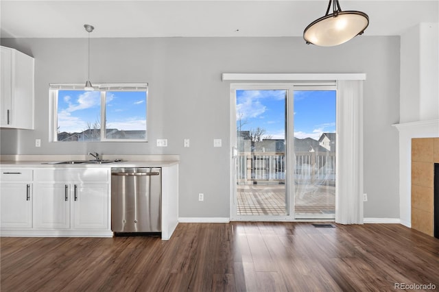 kitchen with dishwasher, pendant lighting, white cabinets, and a healthy amount of sunlight