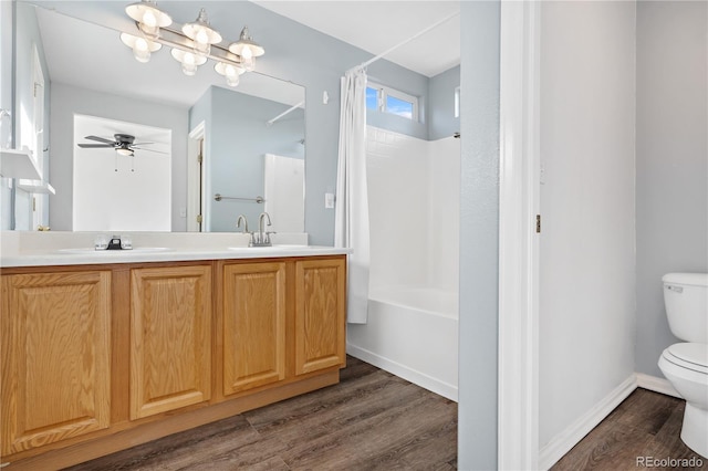 full bathroom featuring shower / bath combination with curtain, vanity, ceiling fan, wood-type flooring, and toilet