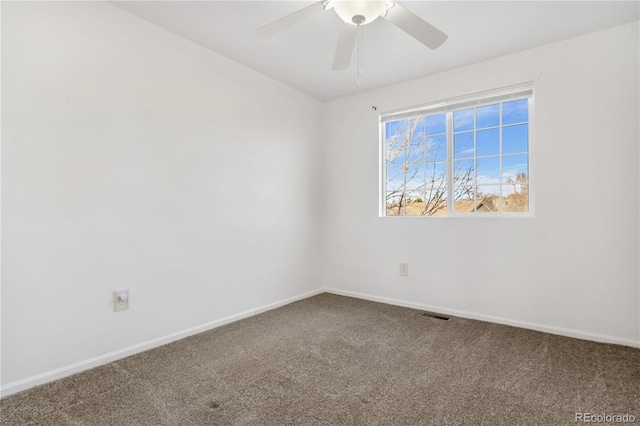 spare room featuring ceiling fan and carpet floors