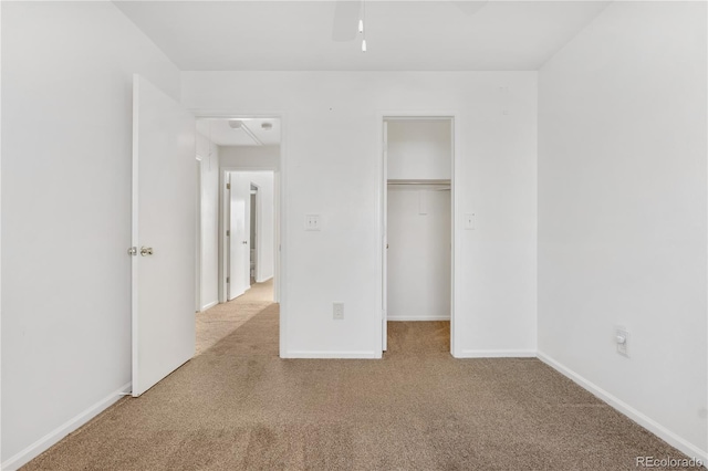 unfurnished bedroom with light carpet and a closet