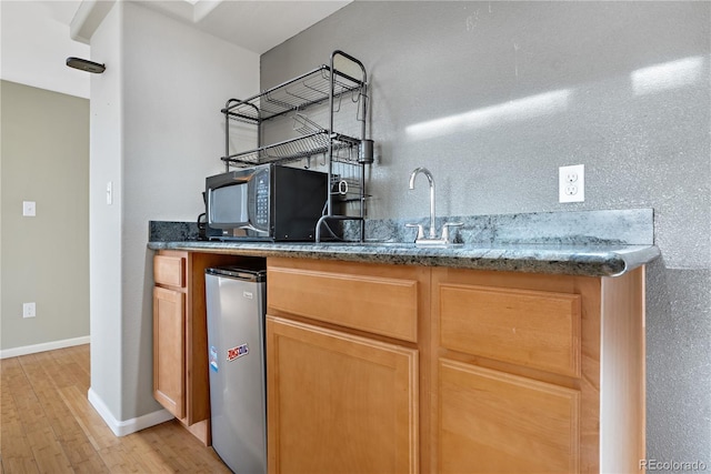 5241 S Shawnee St, Aurora, CO 80015 - indoor wet bar with black microwave, light wood finished floors, and stainless steel refrigerator