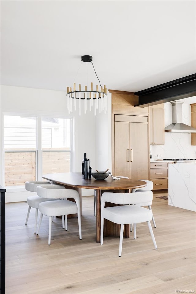 dining room featuring a chandelier and light hardwood / wood-style flooring