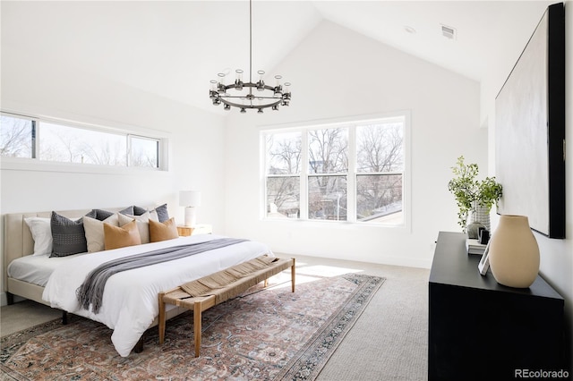 carpeted bedroom with high vaulted ceiling, multiple windows, and a notable chandelier