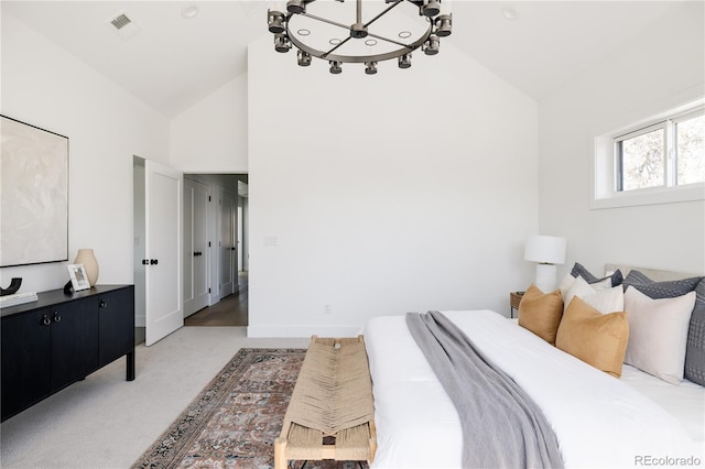 bedroom featuring carpet flooring, a notable chandelier, and high vaulted ceiling