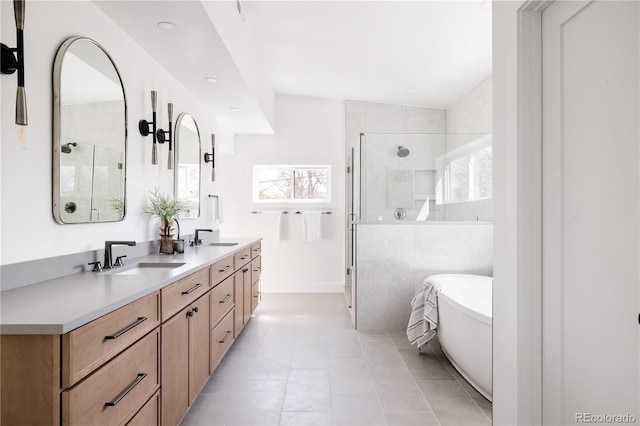 bathroom featuring independent shower and bath, lofted ceiling, tile floors, large vanity, and dual sinks