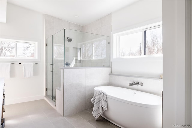 bathroom featuring tile flooring, tile walls, and independent shower and bath