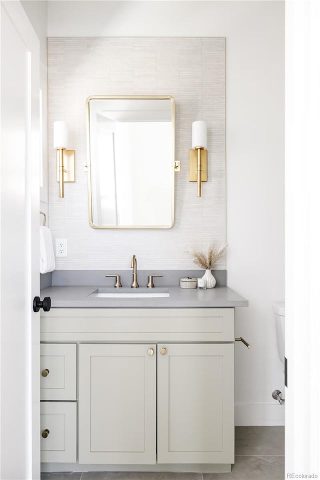 bathroom with tile walls, tile flooring, toilet, and oversized vanity