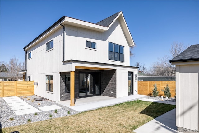 rear view of house with a yard and a patio area