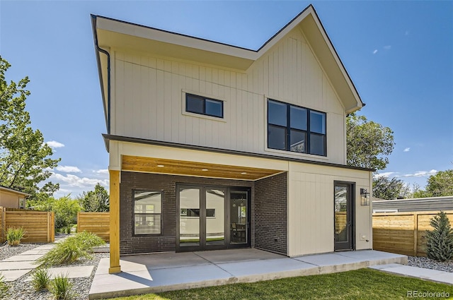 rear view of property featuring fence and a patio area