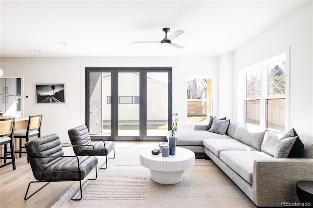 living area featuring light wood-style floors, ceiling fan, and recessed lighting