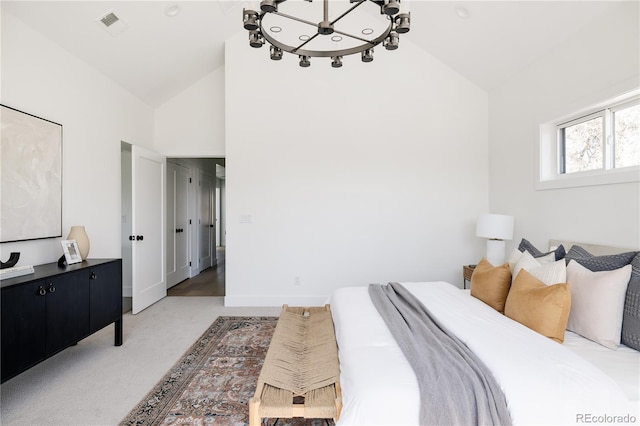 bedroom featuring a chandelier, high vaulted ceiling, light carpet, and baseboards