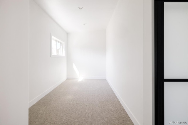 unfurnished room with carpet floors and baseboards