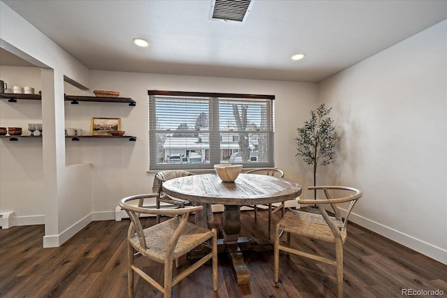 dining area with a baseboard radiator and dark hardwood / wood-style floors