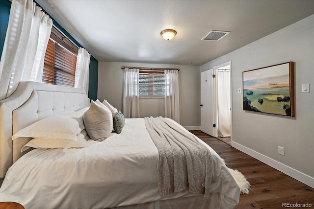 bedroom with dark hardwood / wood-style flooring