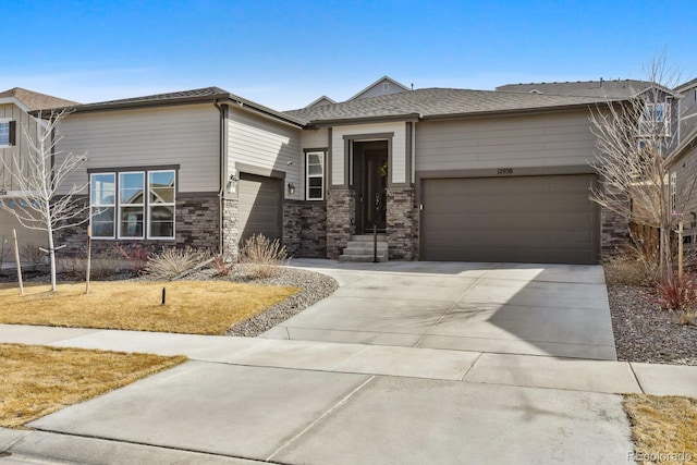 view of front of house with a garage, stone siding, and concrete driveway