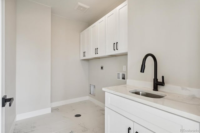 clothes washing area featuring hookup for an electric dryer, washer hookup, cabinets, and sink