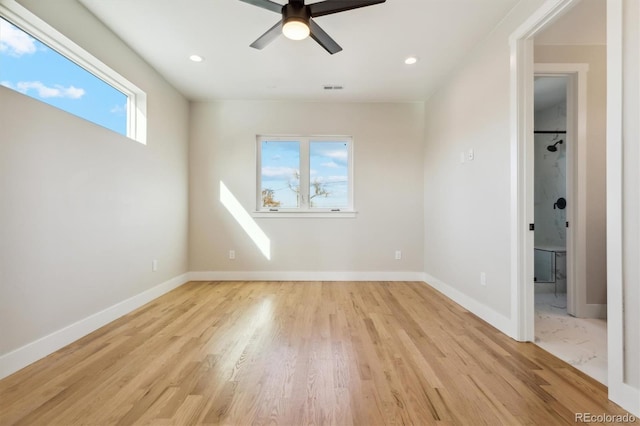 unfurnished room with ceiling fan, a healthy amount of sunlight, and light wood-type flooring