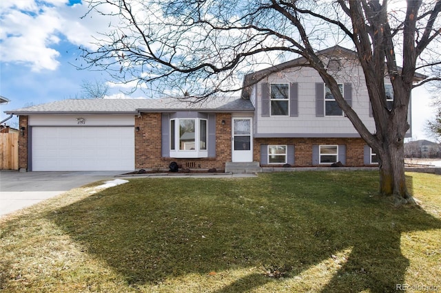 split level home with a garage and a front lawn