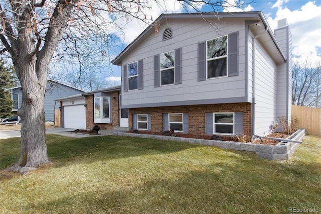 split level home with a garage and a front lawn