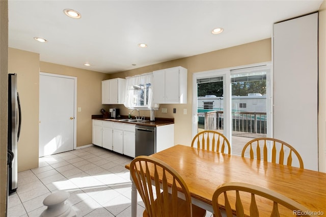 kitchen with light tile patterned flooring, stainless steel appliances, sink, and white cabinets