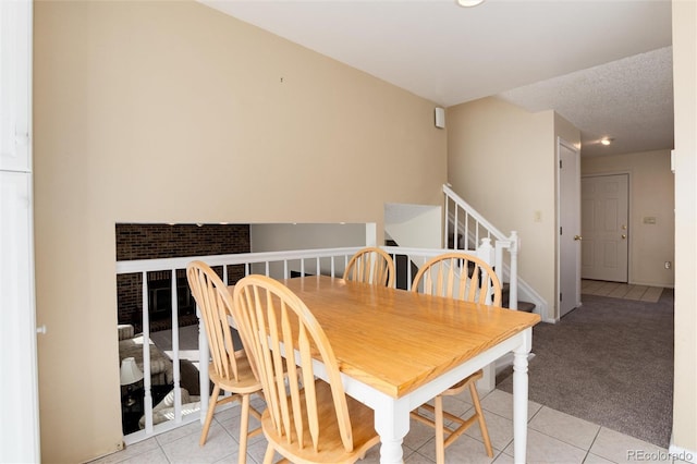 dining space with light tile patterned floors and a textured ceiling