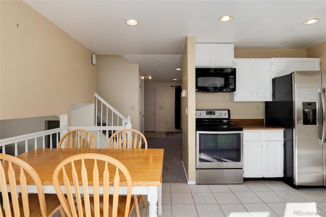 kitchen featuring white cabinetry, appliances with stainless steel finishes, and light tile patterned flooring