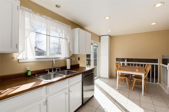 kitchen with sink, a wealth of natural light, white cabinets, and dishwasher