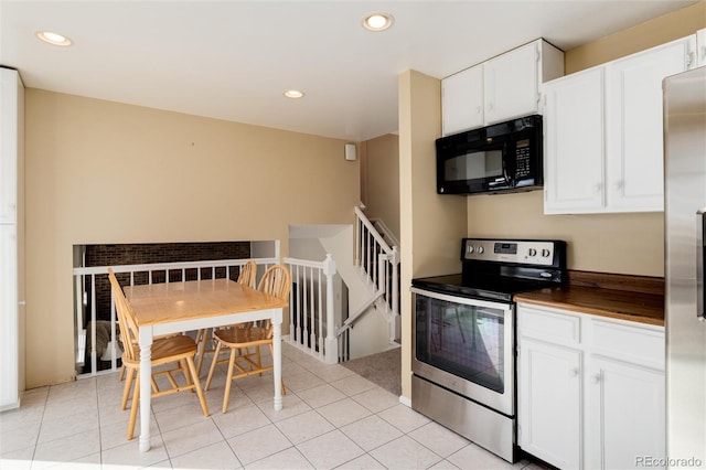 kitchen with light tile patterned floors, white cabinets, and appliances with stainless steel finishes