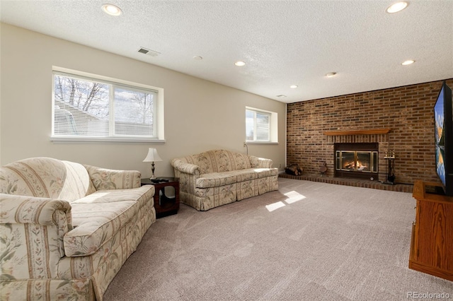 carpeted living room featuring a textured ceiling and a fireplace