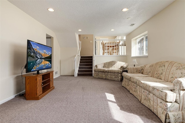 living room with light carpet and a textured ceiling